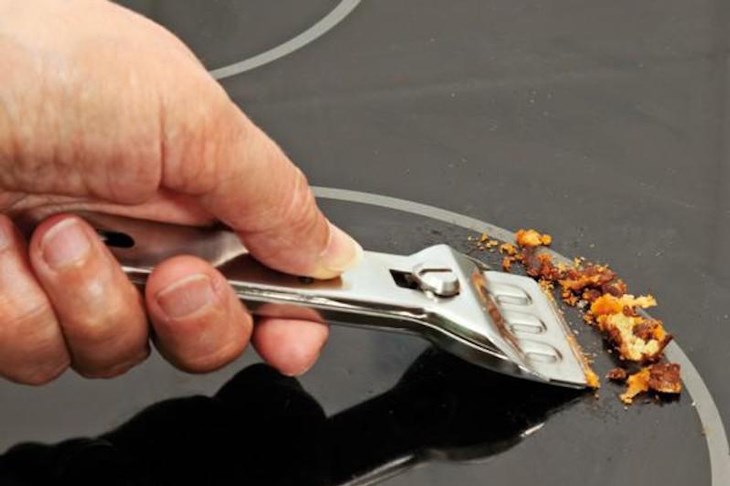 Cạo sạch các vết cháy khét và mảng thức ăn bám lâu ngày trên bề mặt bếp Cạo sạch các vết cháy khét và mảng thức ăn bám lâu ngày trên bề mặt bếp