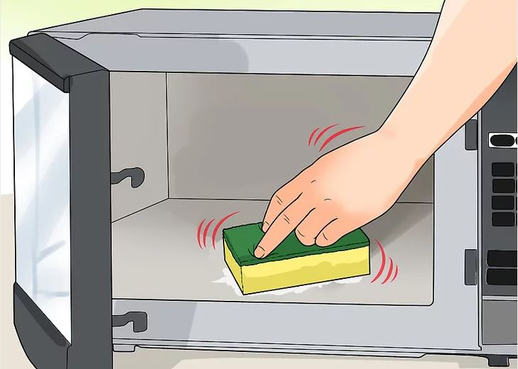 Sử dụng miếng bọt biển nguội để lau lò vi sóng Sử dụng miếng bọt biển nguội để lau lò vi sóng